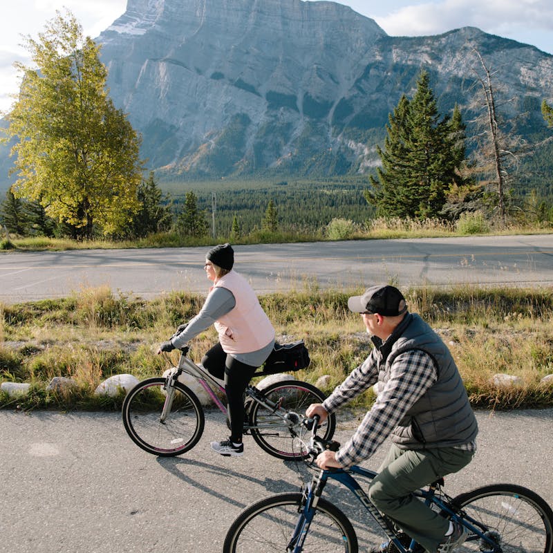 Tina and Craig riding bikes through nature and taking in the views.