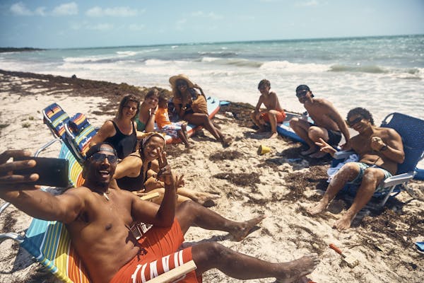 The Lane family and their friends take a selfie at the beach