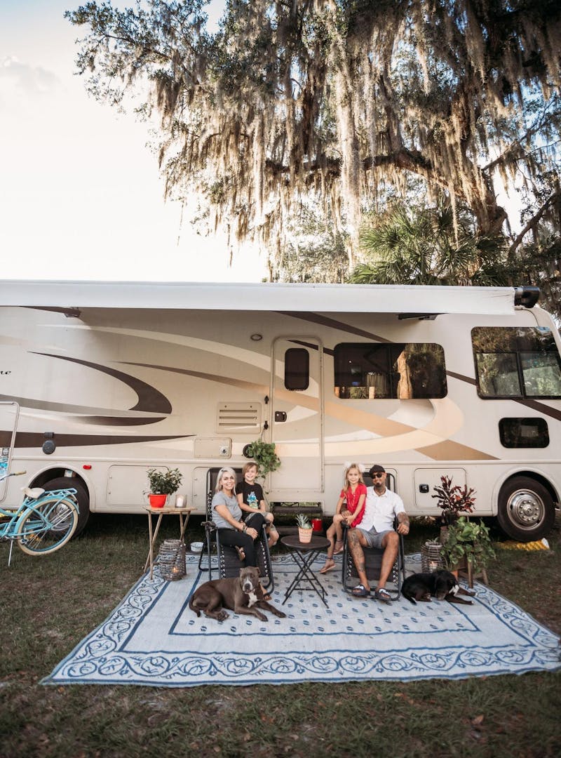 Justin Russell and his family pose for a picture in front of their 2016 Thor Hurricane Class A RV.