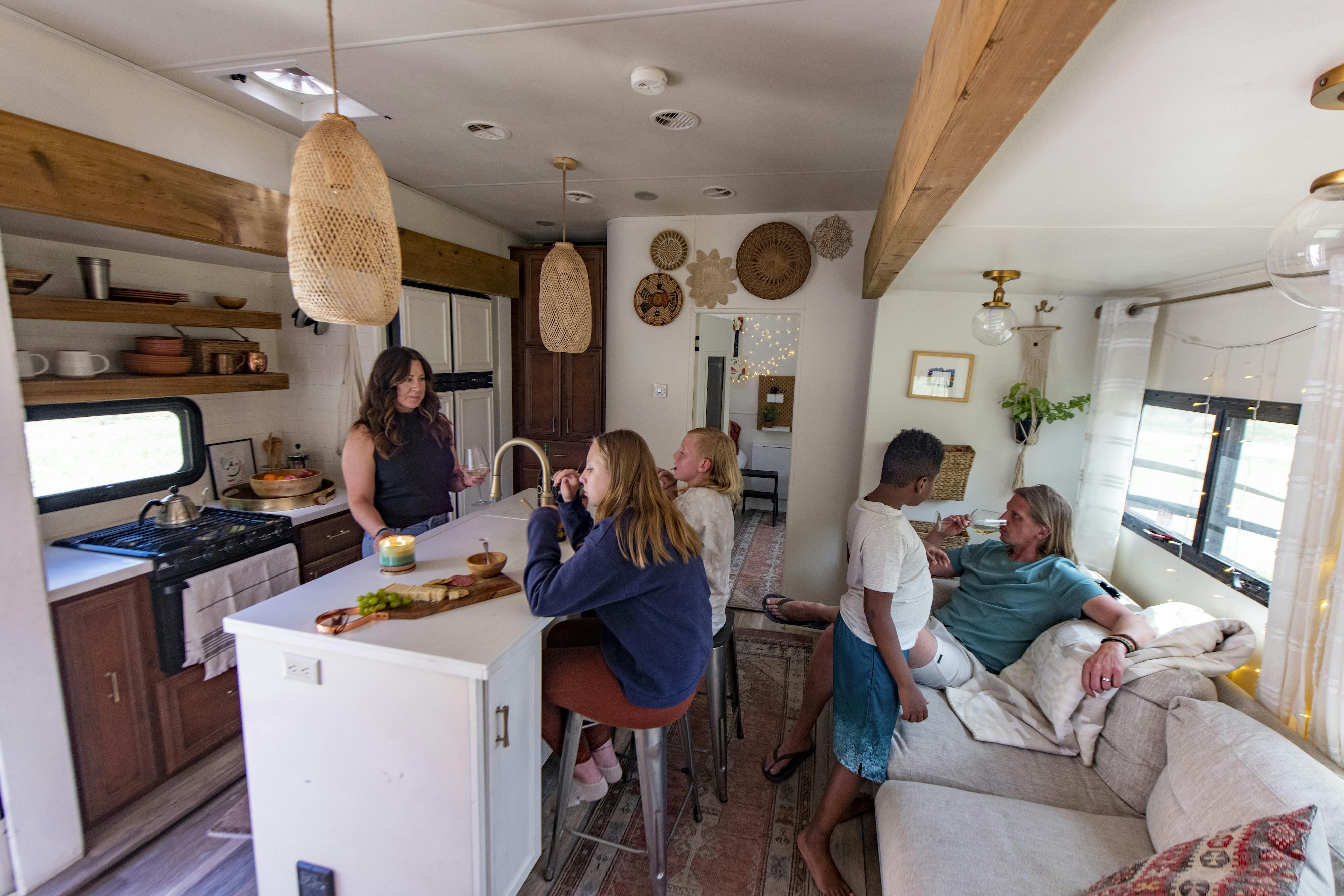 The Carew family relaxing inside the kitchen and living area of their RV