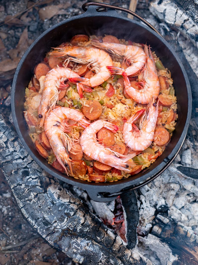 Cooked shrimp lined up on top of finished Jambalaya.