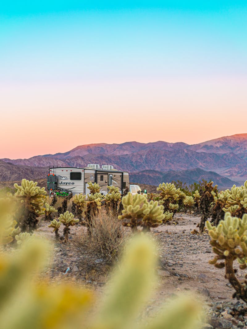Renee Tilby's RV parked by mountain dessert at sunset
