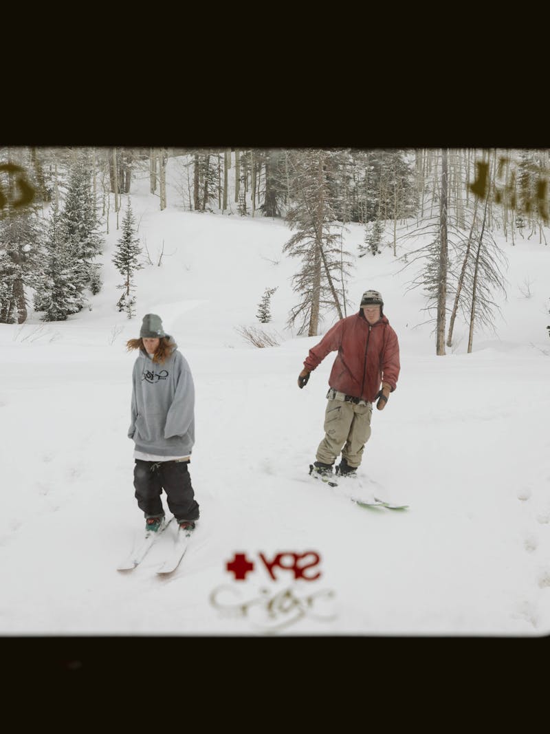 Ryan Barrick and a friend skiing outside an RV window.