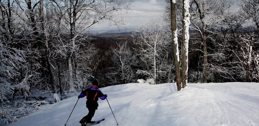 Skier at the top of a hill at Roundtop Mountain in Lewsiberry, PA