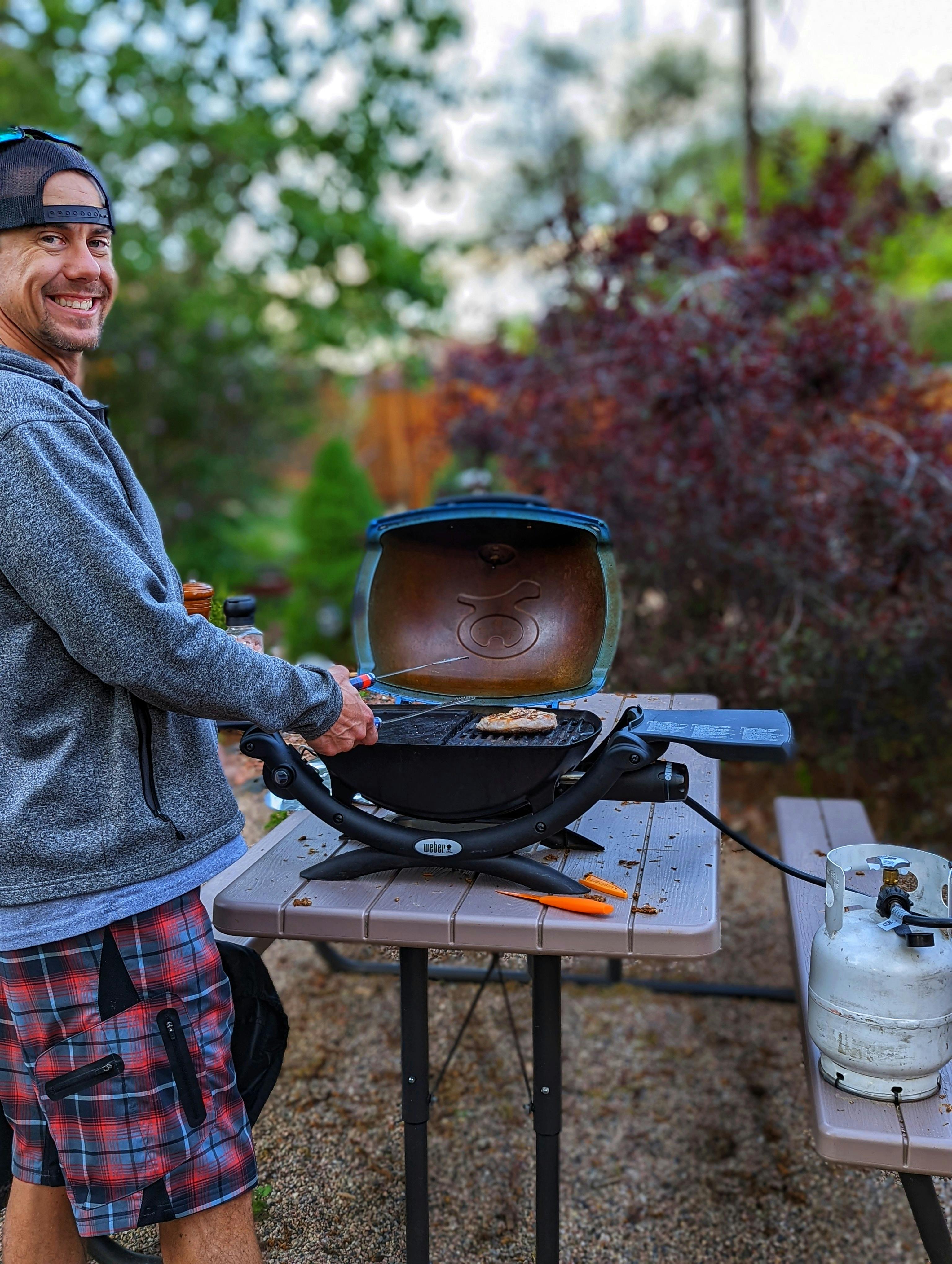 Dustin Bauer grilling with a reusable propane tank