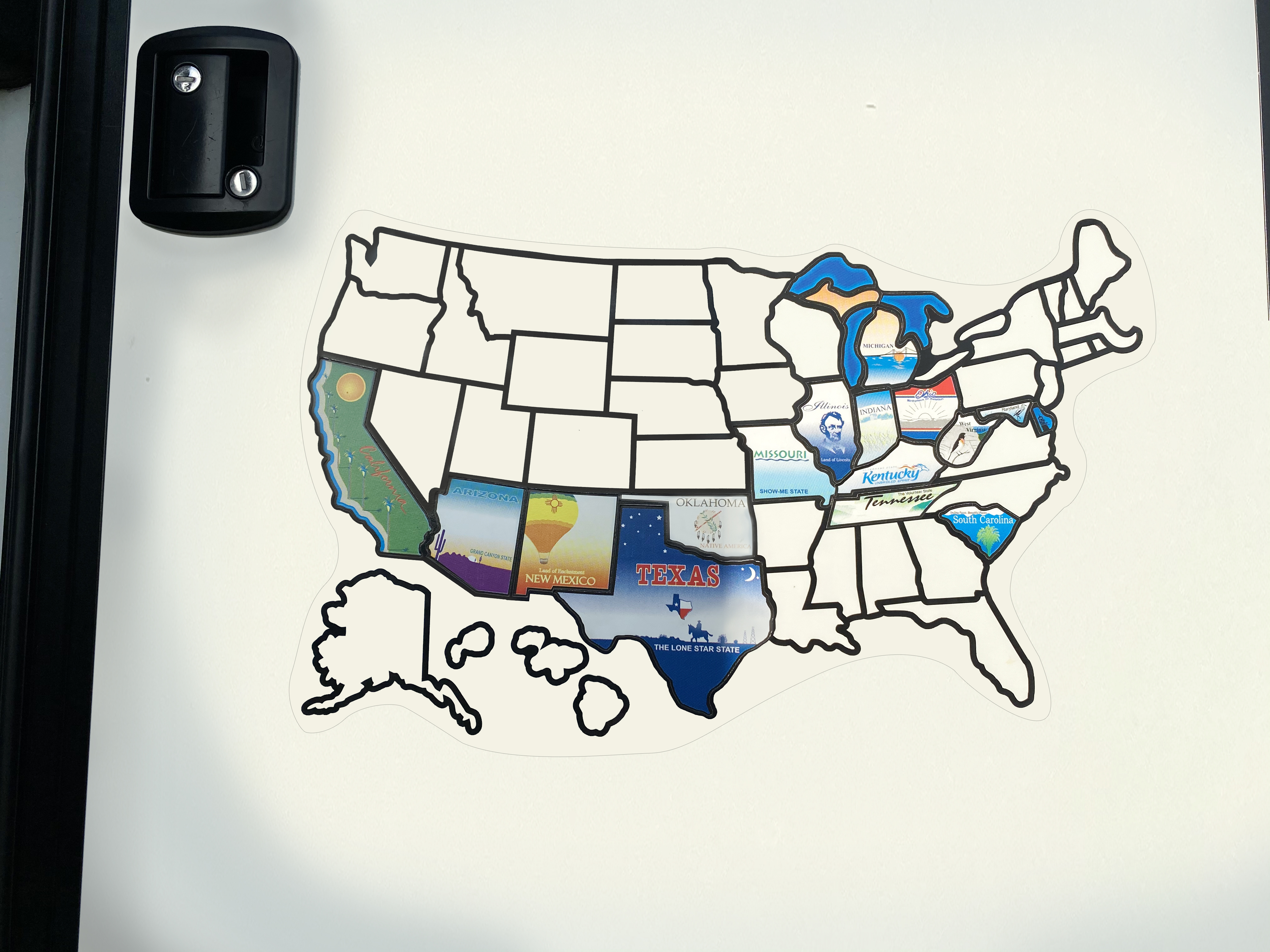 A sticker map on the back on an RV with different states colored in.