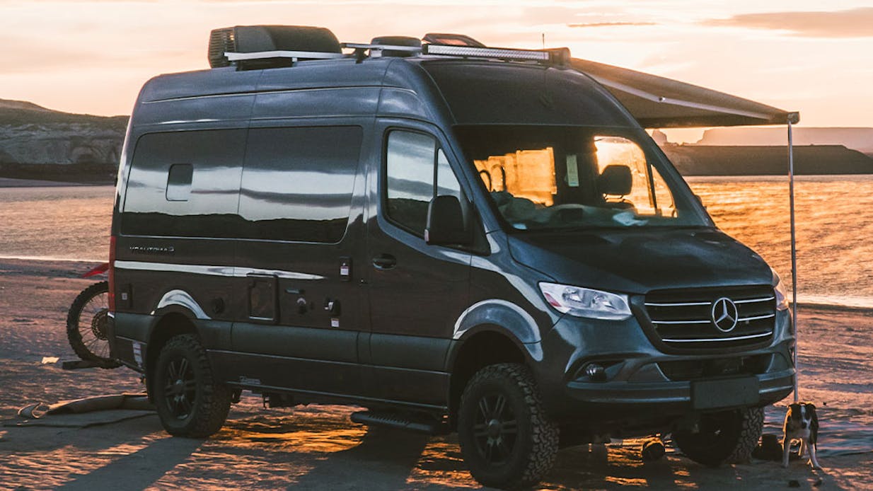 Sanctuary sprinter $5,000 rebate with dogs and sunset in background