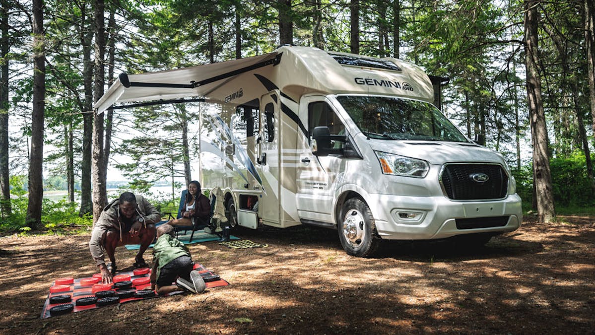 Thor Gemini AWD Class B+ RV in Maine with family playing chess outside