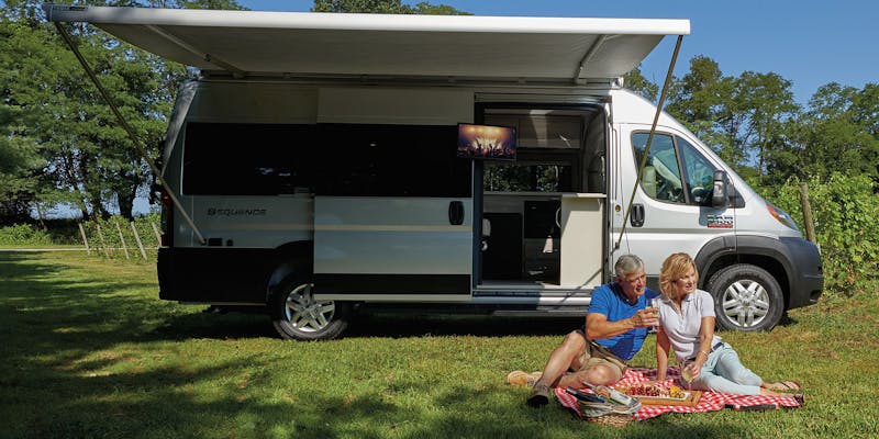 2020 Thor Sequence Class B Camper Van RV lifestyle winery photo shoot couple sitting on picnic blanket at winery slider size 2000 x 800px