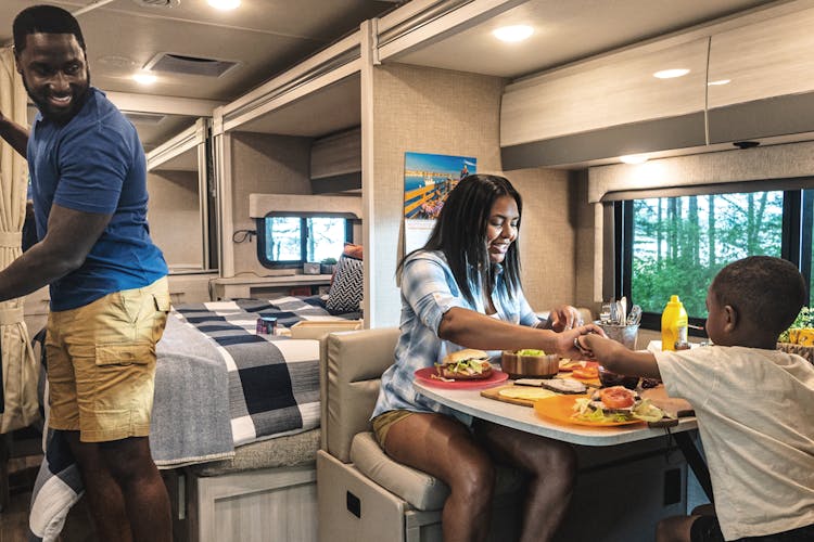 2022 Thor Gemini Class B+ RV Lifestyle Maine Corporate photo shoot interior shot of family eating