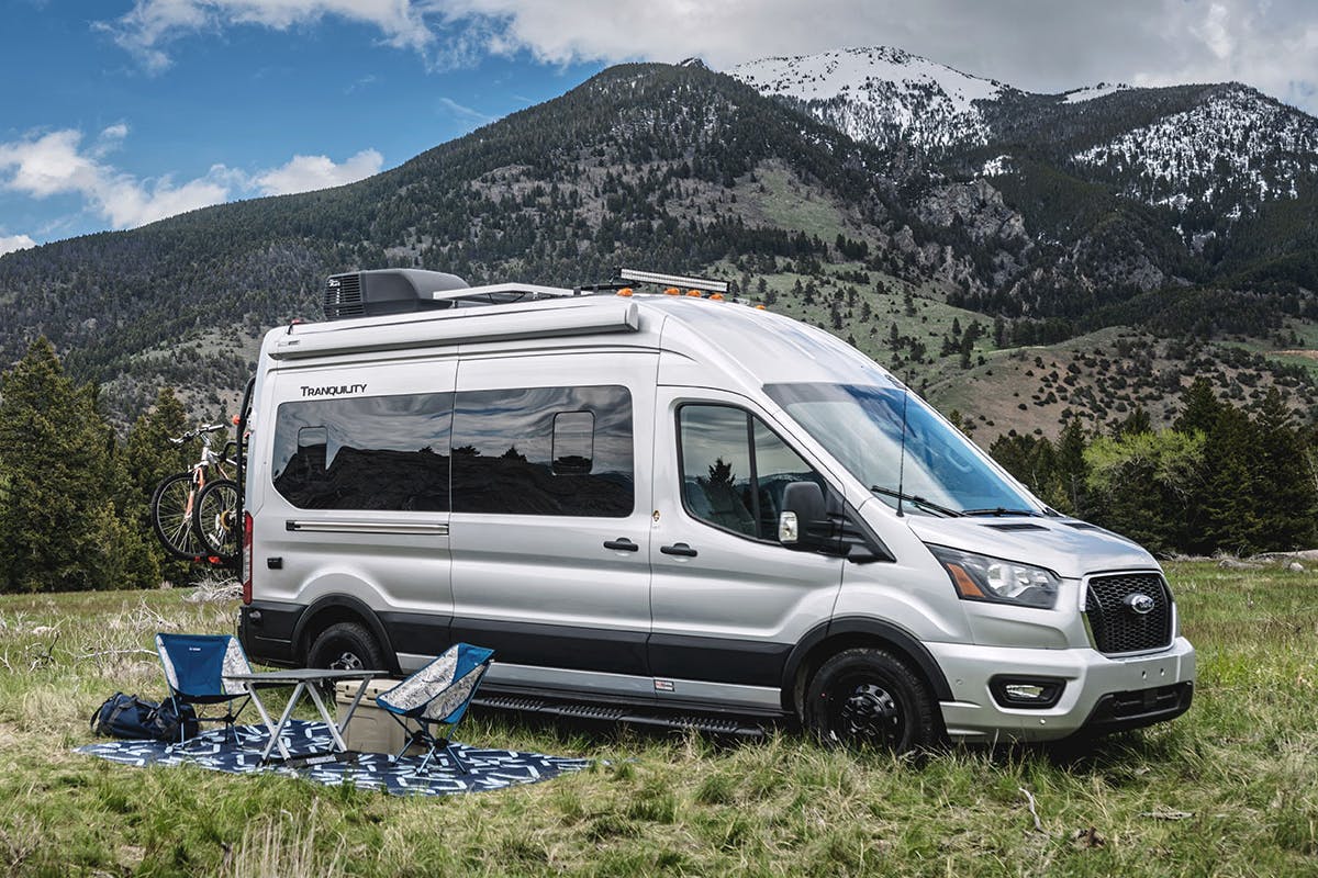 Tranquility Camper Van with outdoor setup in front of big mountain