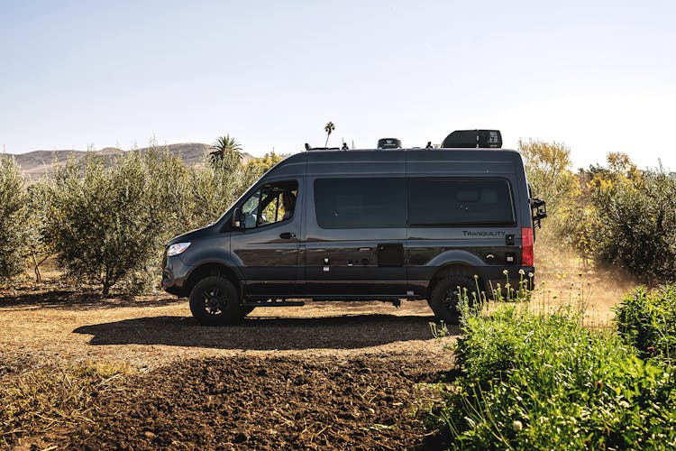 2023 Tranquility Sprinter in charcoal paint driving on dirt road in desert