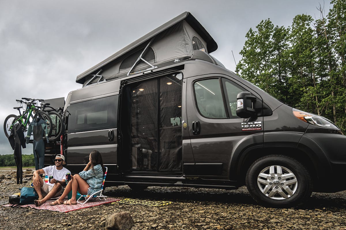 2022 Thor Scope Class B RV Camper Van Lifestyle Maine Corporate photo shoot at campsite couple seated slider size