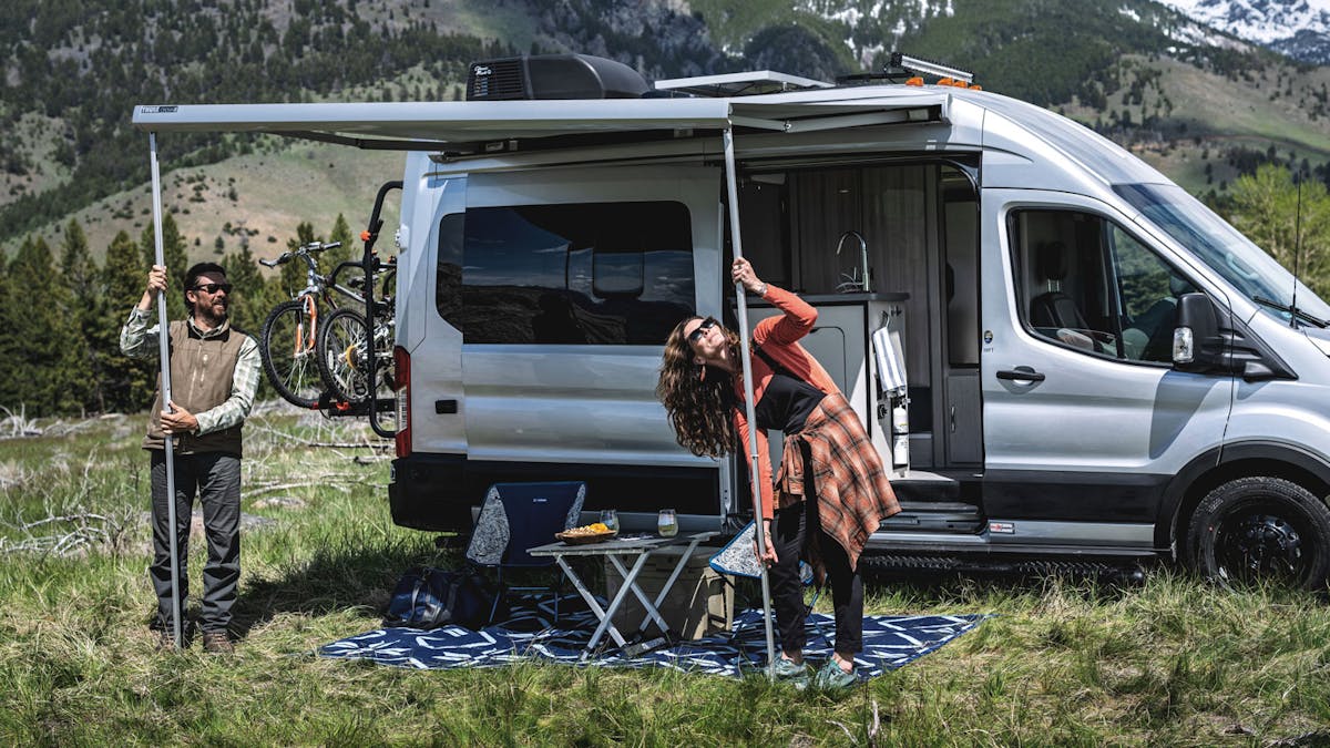 Effortlessly setting up awning at campsite in Montana with camper van