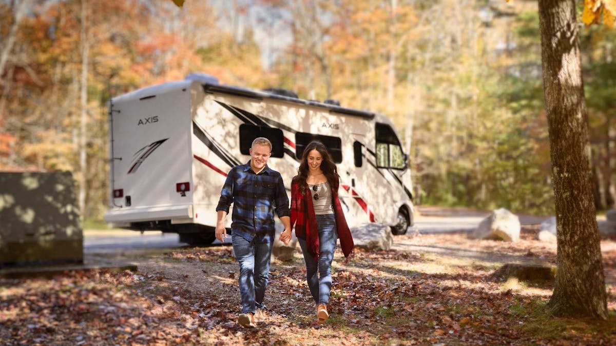 Thor Axis Class A RV Lifestyle family walking in Tennessee fall leaves scenery