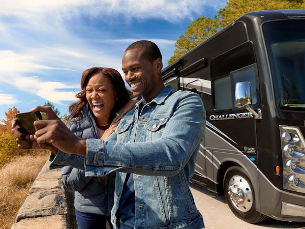 2022 Thor Challenger Class A RV Lifestyle Tennessee Couple laughing and taking selfie close up fall leaves