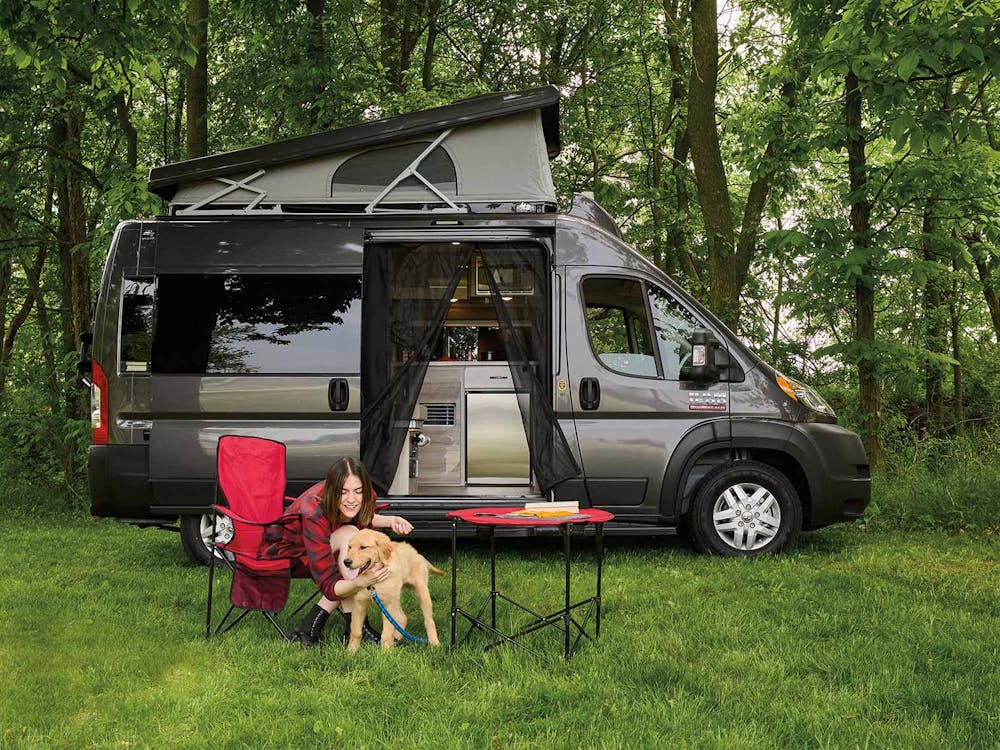2022 Thor Scope Class B RV Lifestyle woman with dog sideview of camper van 