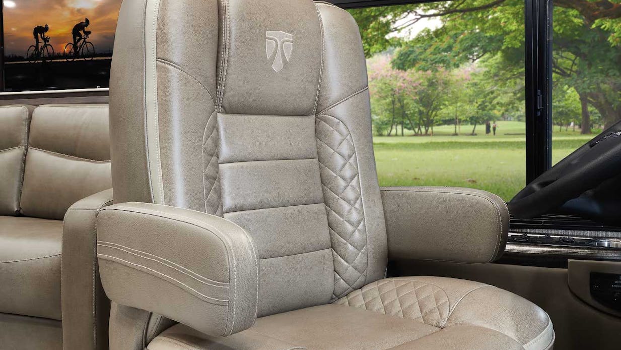 Aria captain's chair with lumbar support and greenery behind