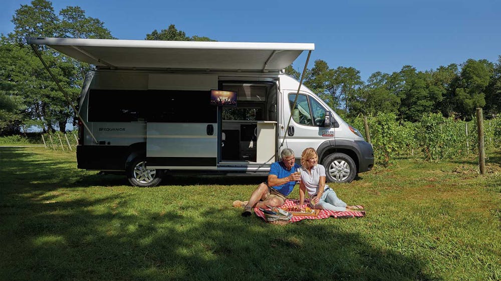 2020 Thor Sequence Class B Camper Van RV lifestyle winery photo shoot couple sitting on picnic blanket at winery