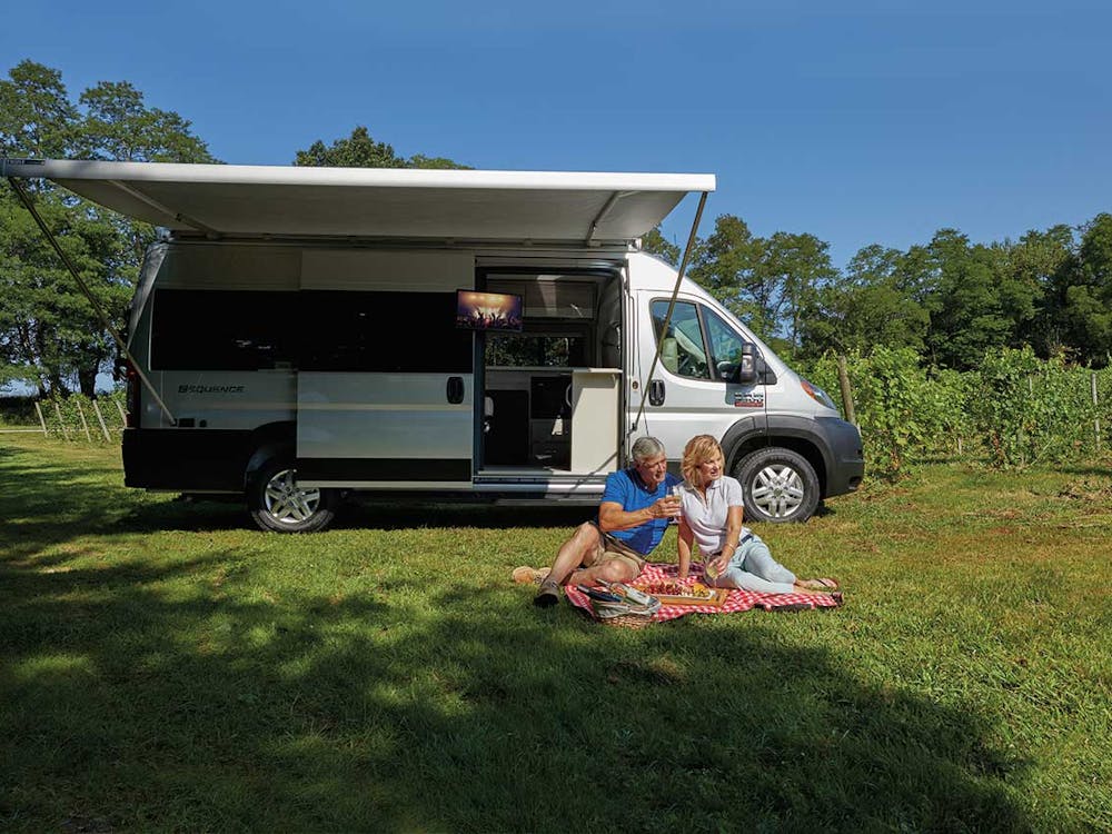 2020 Thor Sequence Class B Camper Van RV lifestyle winery photo shoot couple sitting on picnic blanket at winery