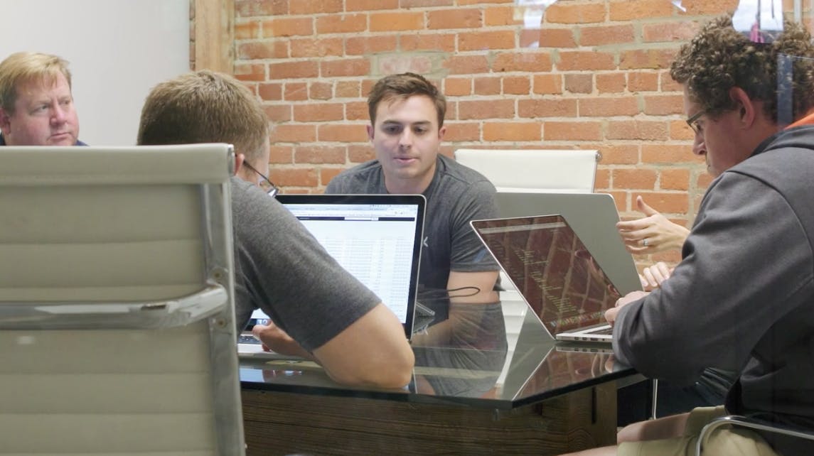 The Adwerx team shown sitting at a table