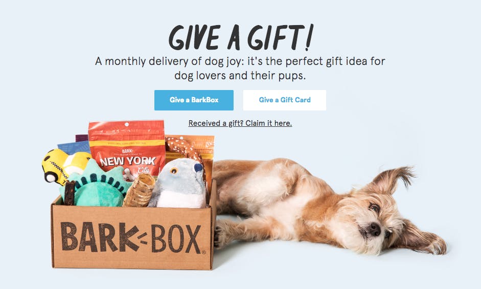 Bark & Co interface screenshot with a dog lying next to a Barkbox; Text reads: Give a Gift! A monthly delivery of dog joy: It's the perfect gift idea for dog lovers and their pups.