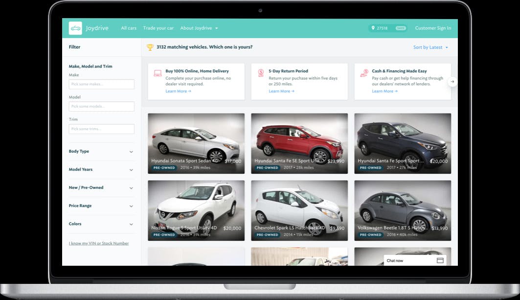 A laptop shows the Joydrive car listing page for purchasing