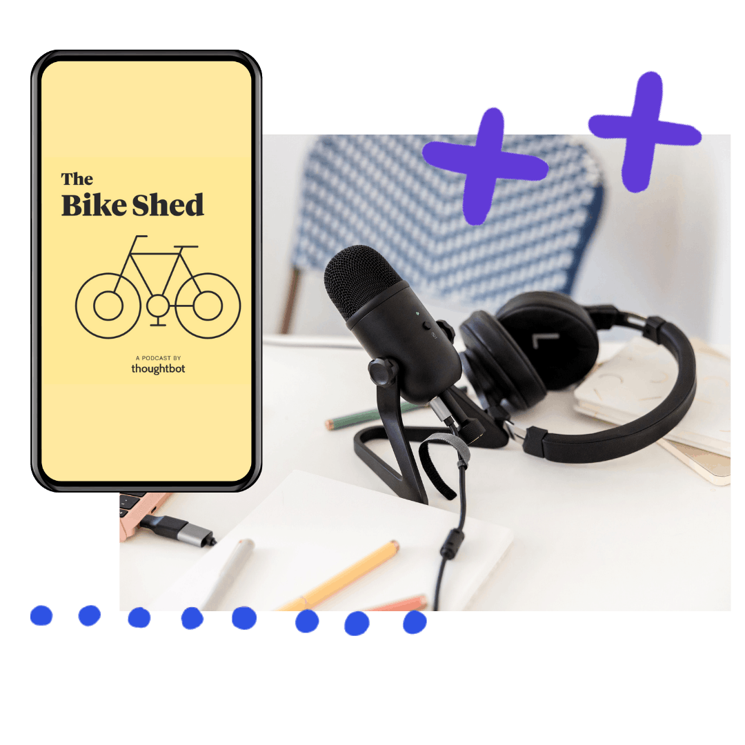 cellphone playing the bike shed podcast next to a microphone and headphones