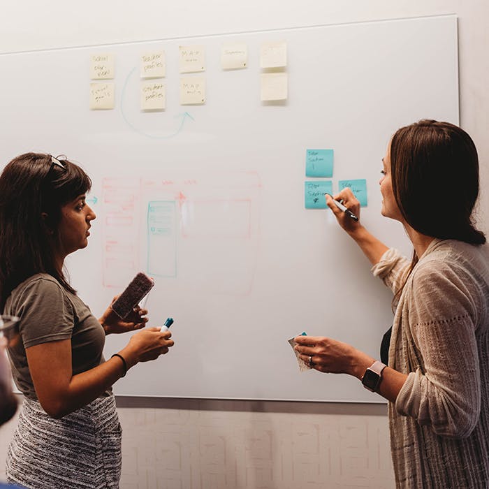 thoughtbot Designers working on React Native mobile app at a whiteboard