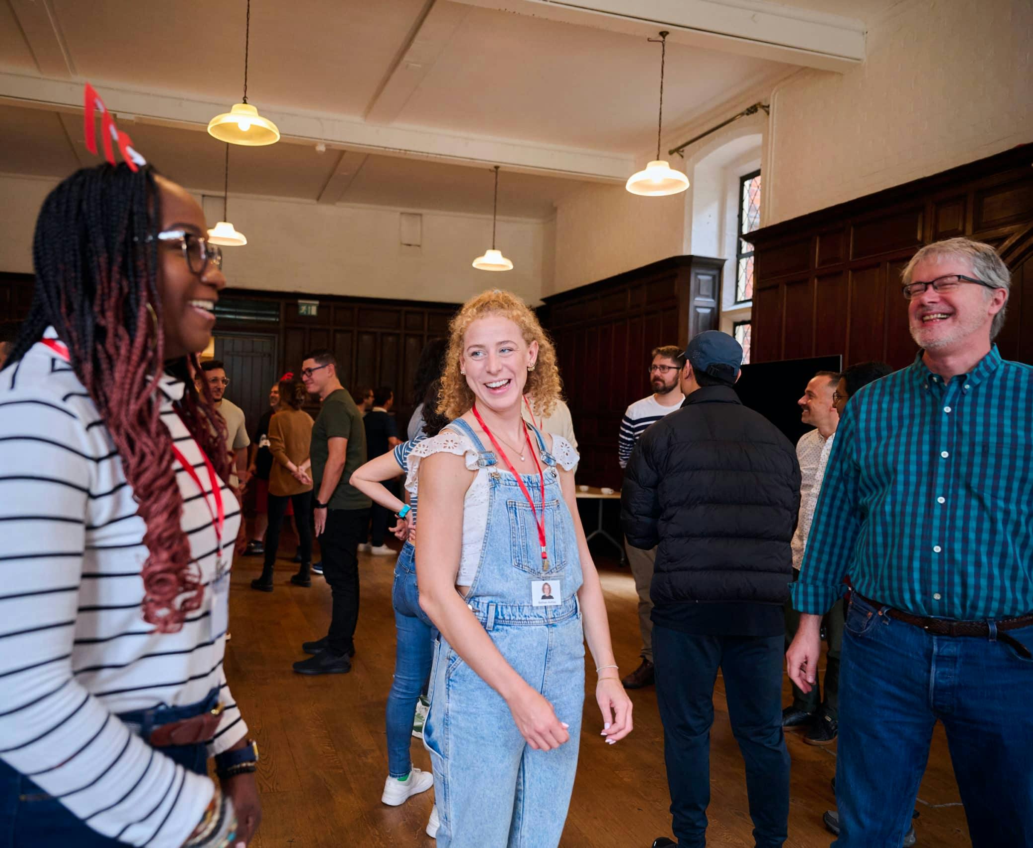 Three thoughtbotters standing and laughing. 