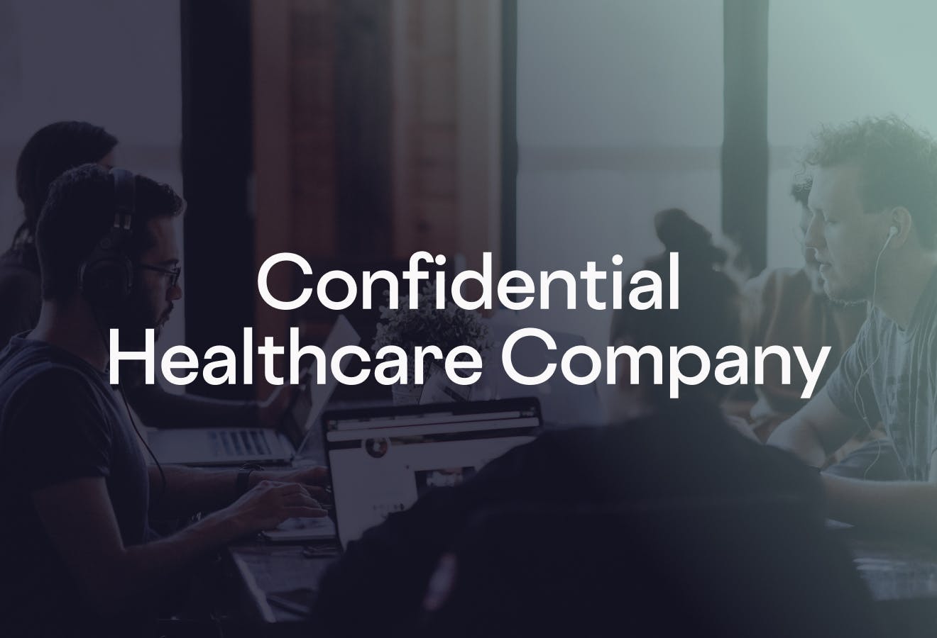 Four people gathered at a table with their laptops in a meeting room. The text, "Confidential Healthcare Company" is overlaid on top.