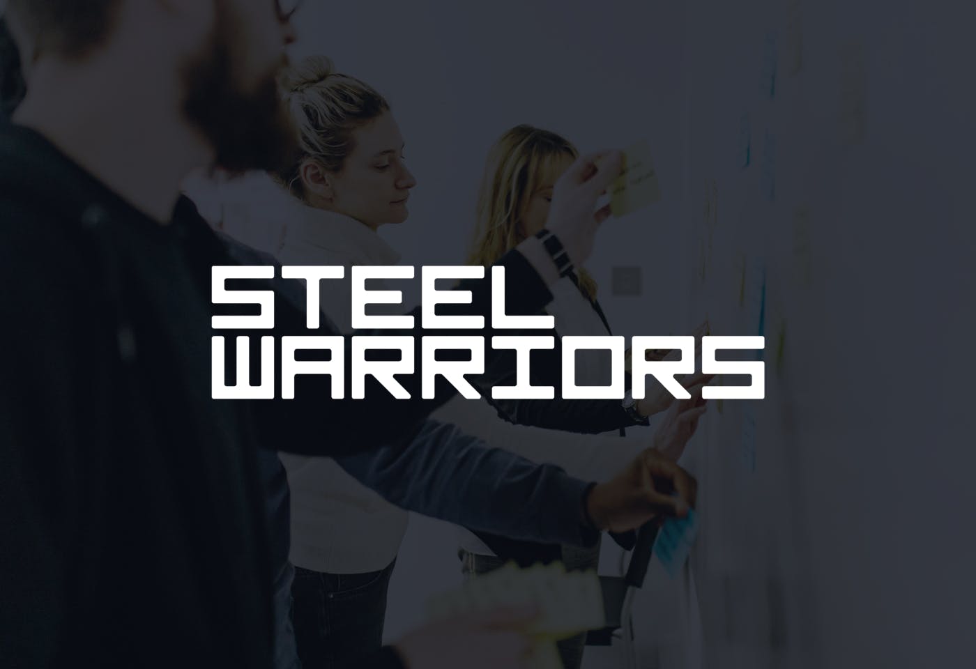 The Steel Warriors logo on a dark background in front of an image of people conducting a whiteboard exercise.