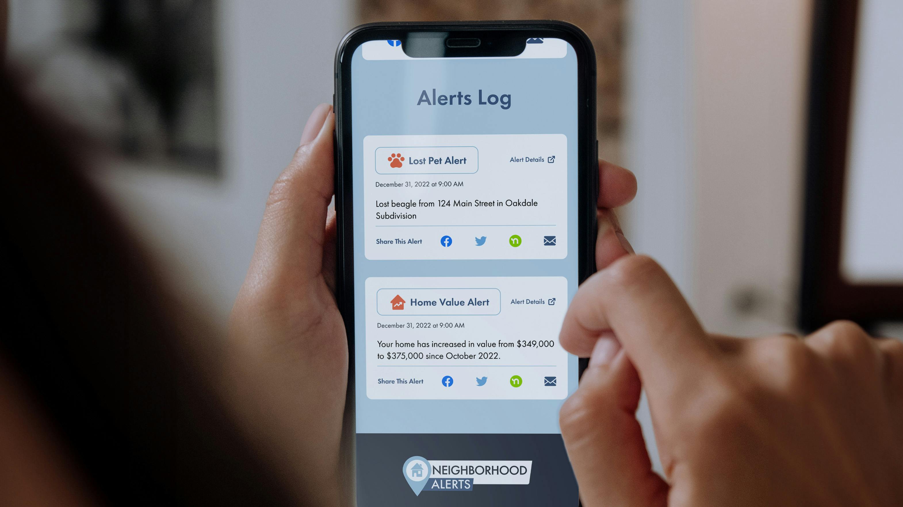 Person holding a phone with the Neighborhoods Alerts product opened to the Alerts Log.