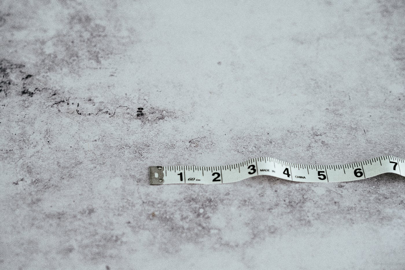 A measuring tape showing 1 thru 7 on a marble counter