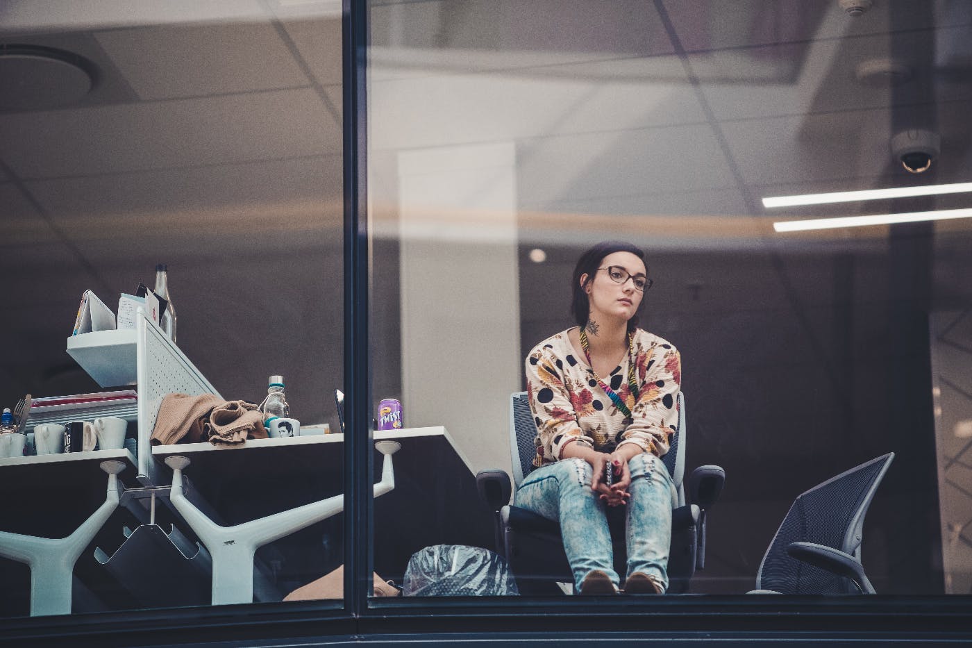 A woman in her office looking longingly out the window