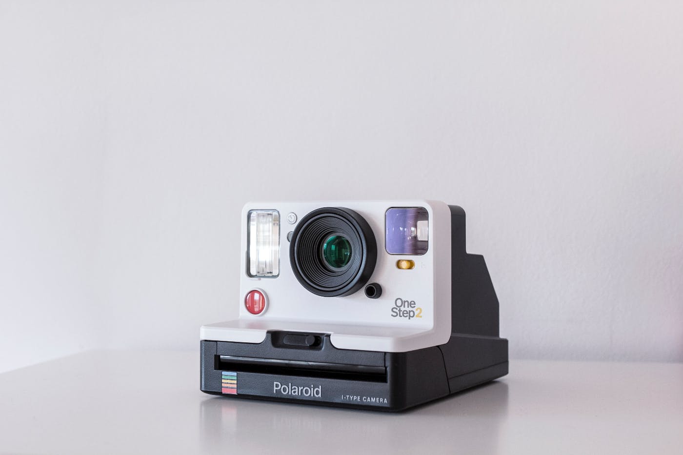 A white and black Polaroid One Step2 camera