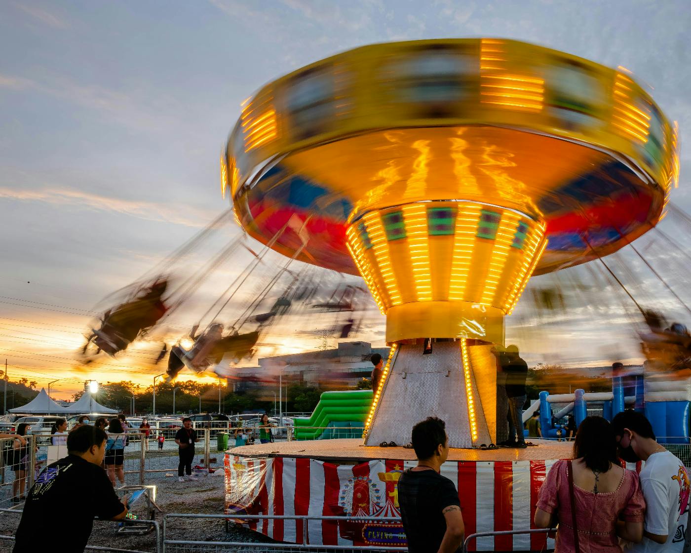 A lighted spinning ride at a fair