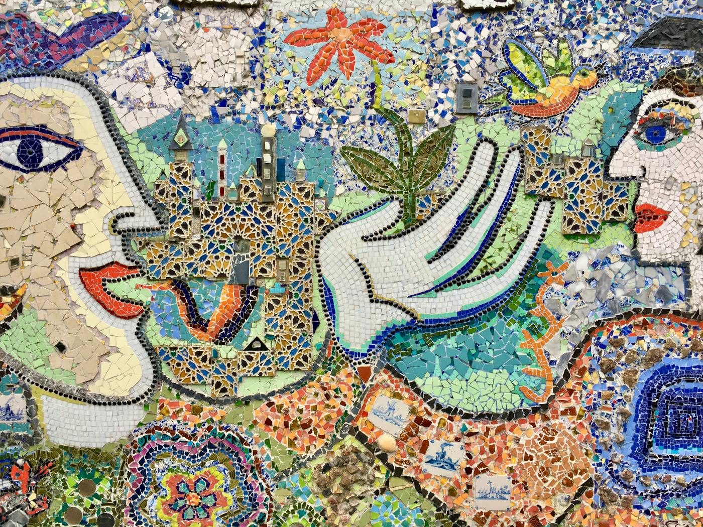 A colorful tile mosaic depicting two people talking