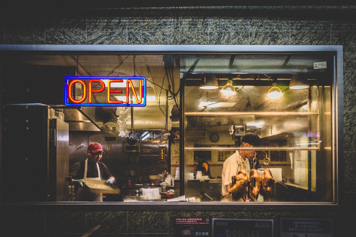 Two men in the window of a Chinese restaurant
