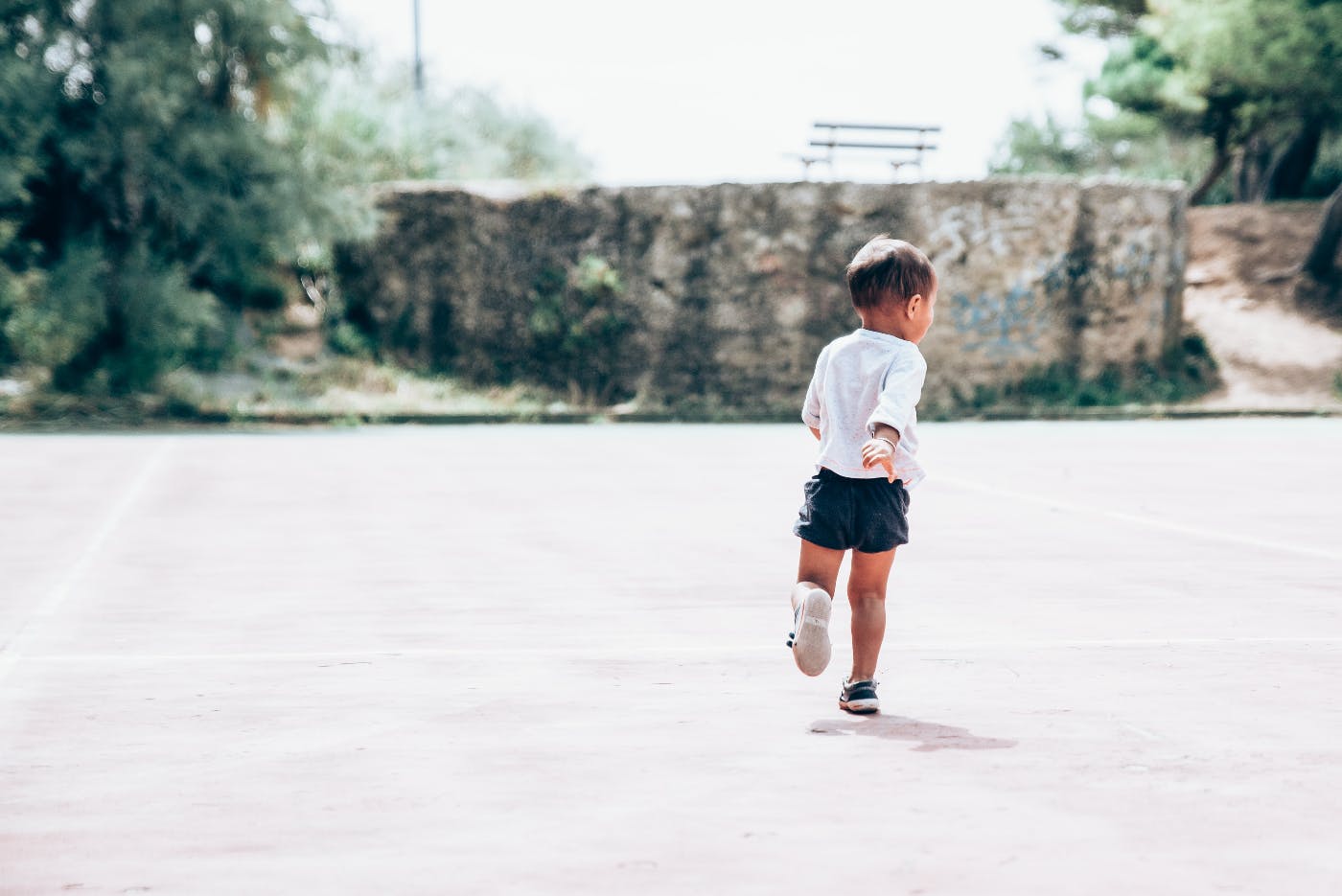 A small boy playing in the street