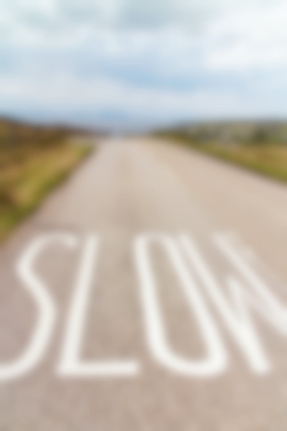 a seaside street with the word slow painted on the road