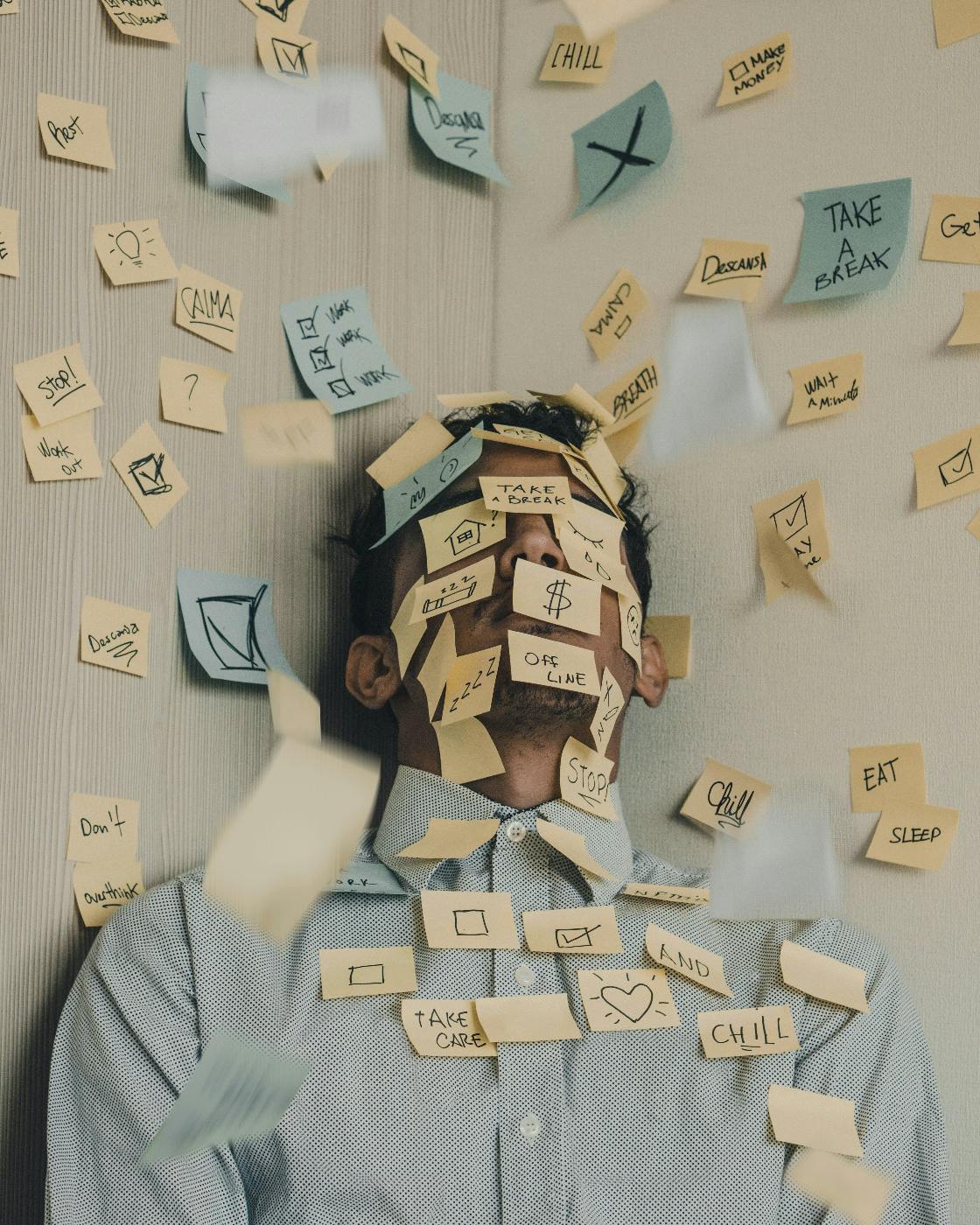 A man in a corner covered with sticky notes