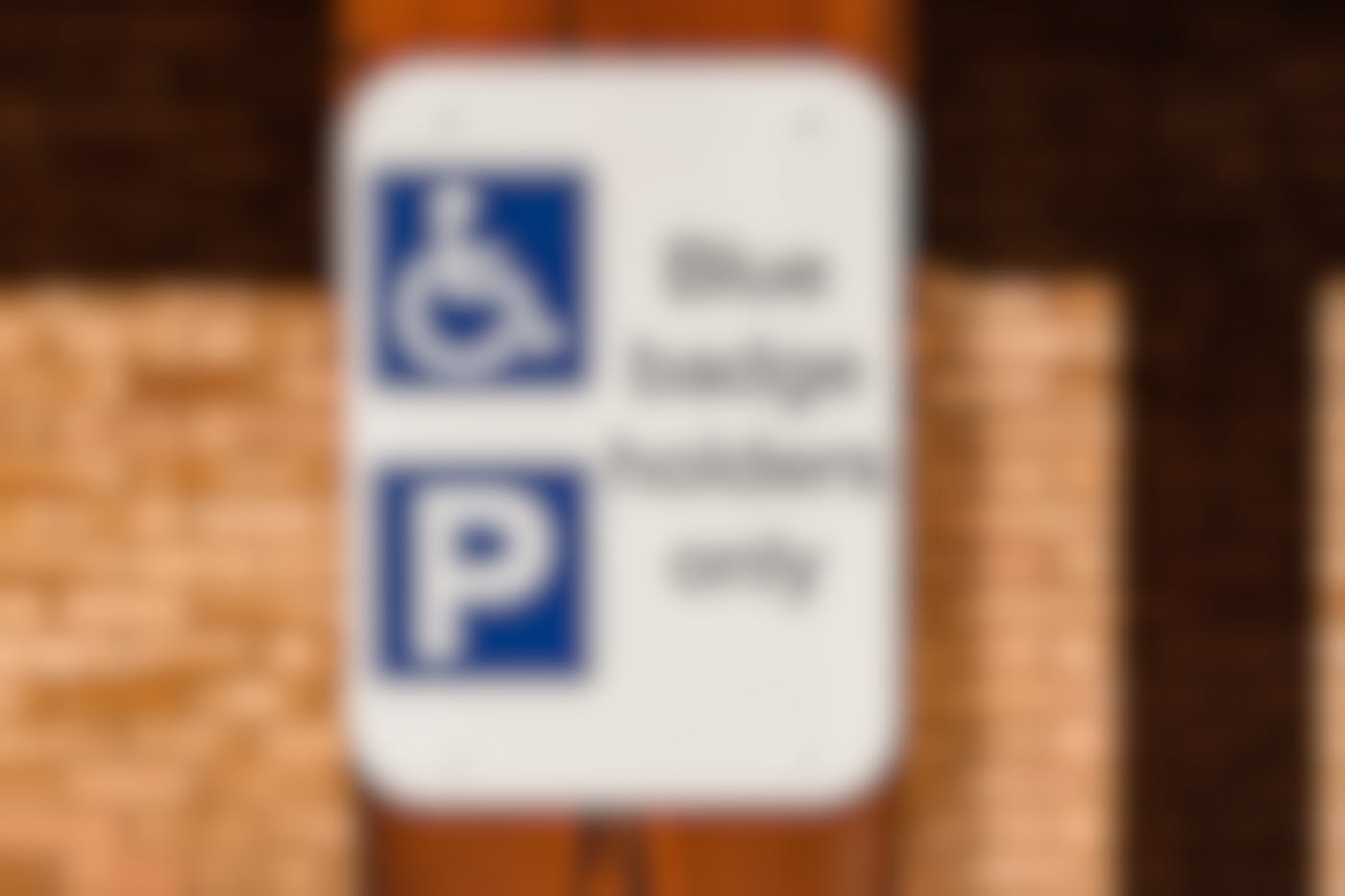 a sign reading blue badge holders only and the handicapped symbol