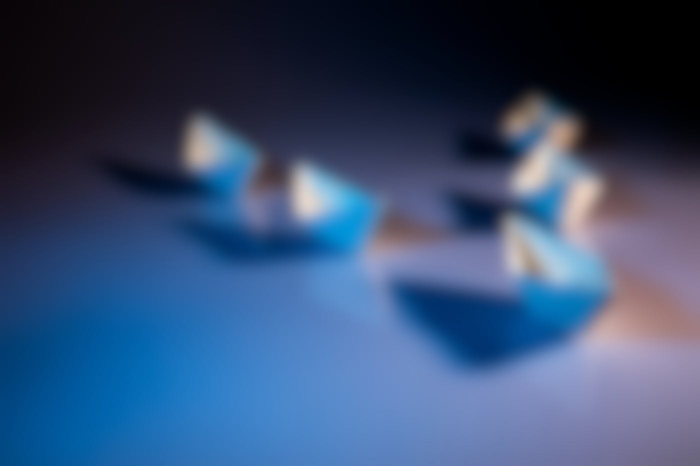 Five blue paper boats