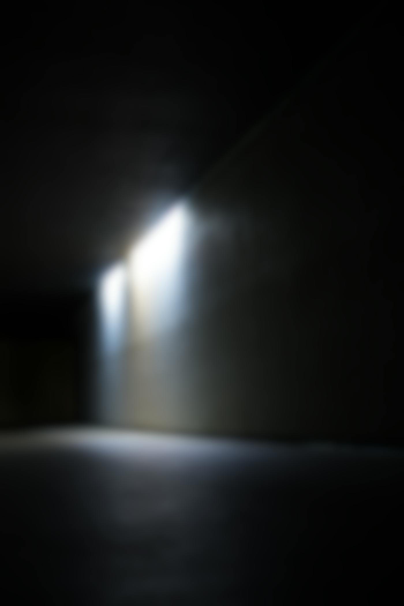 A shadowy, dimmly lit corridor. 