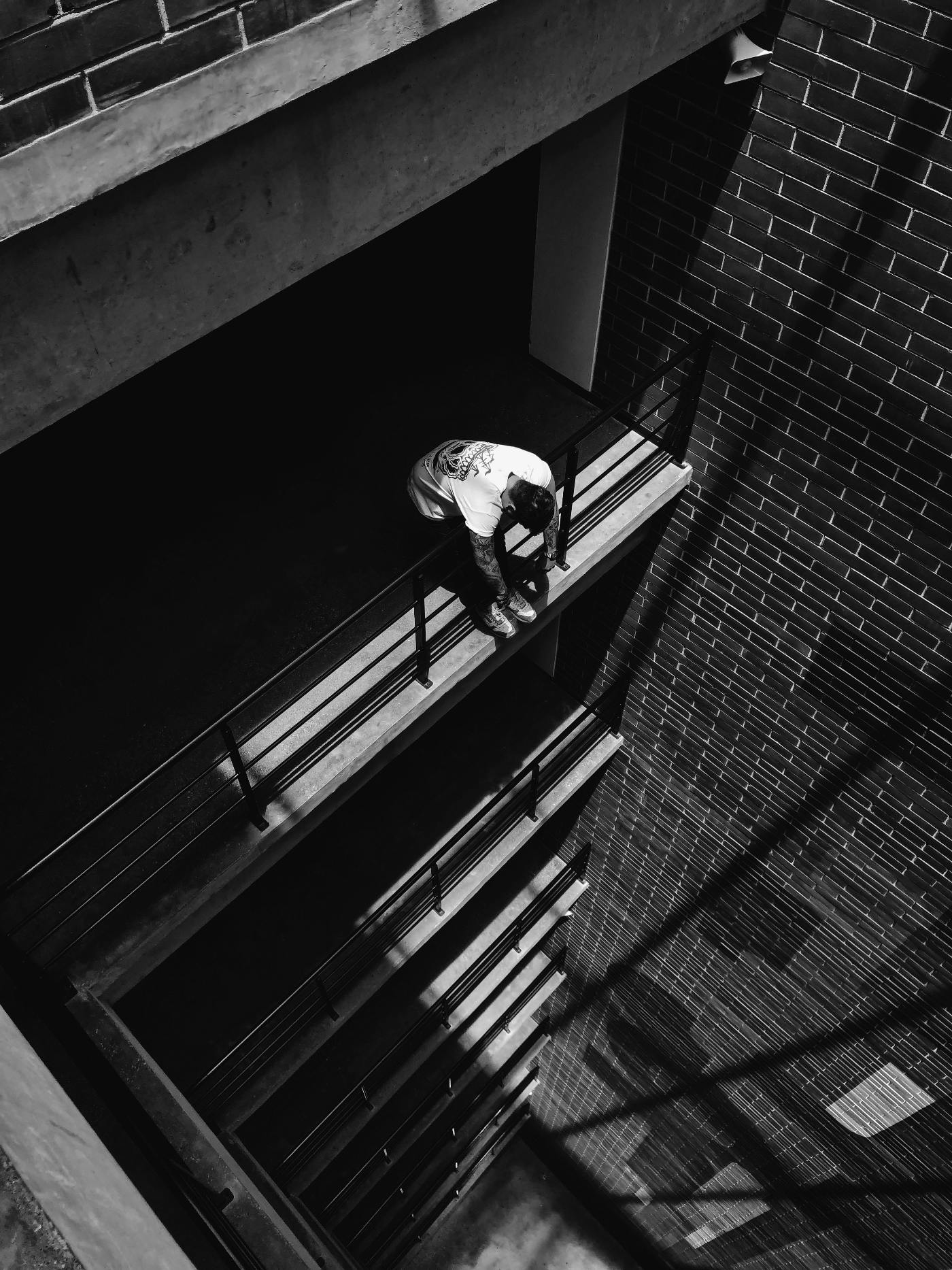 a man hanging over a balcony