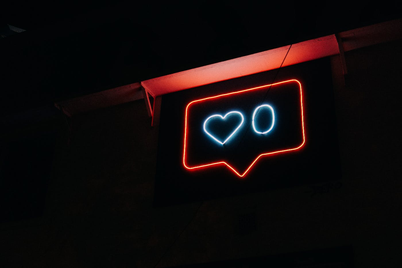 A neon chat box with heart zero