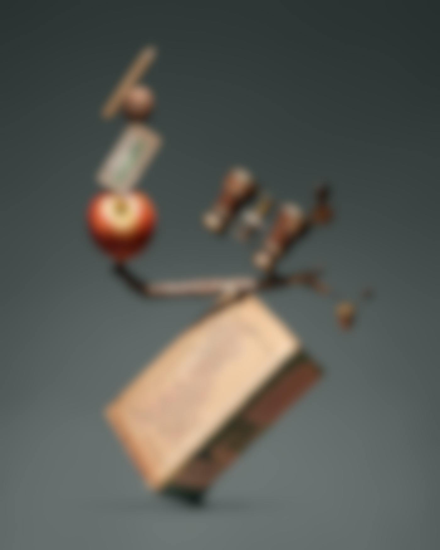 A pencil, walnut, apple, twig, opera glasses and a road map all tumbling together