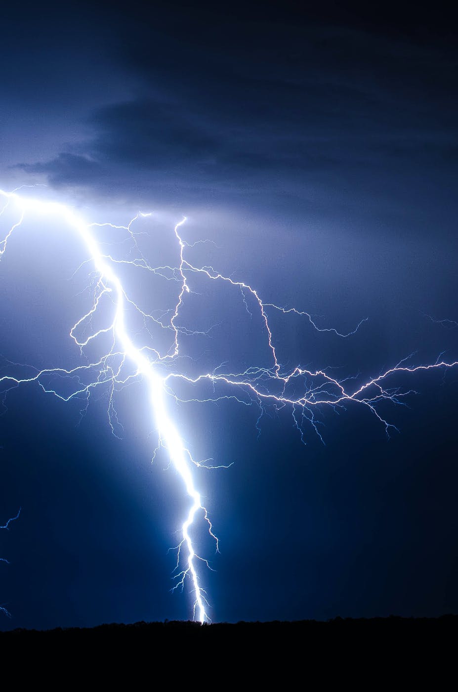 Lightning striking the earth at night