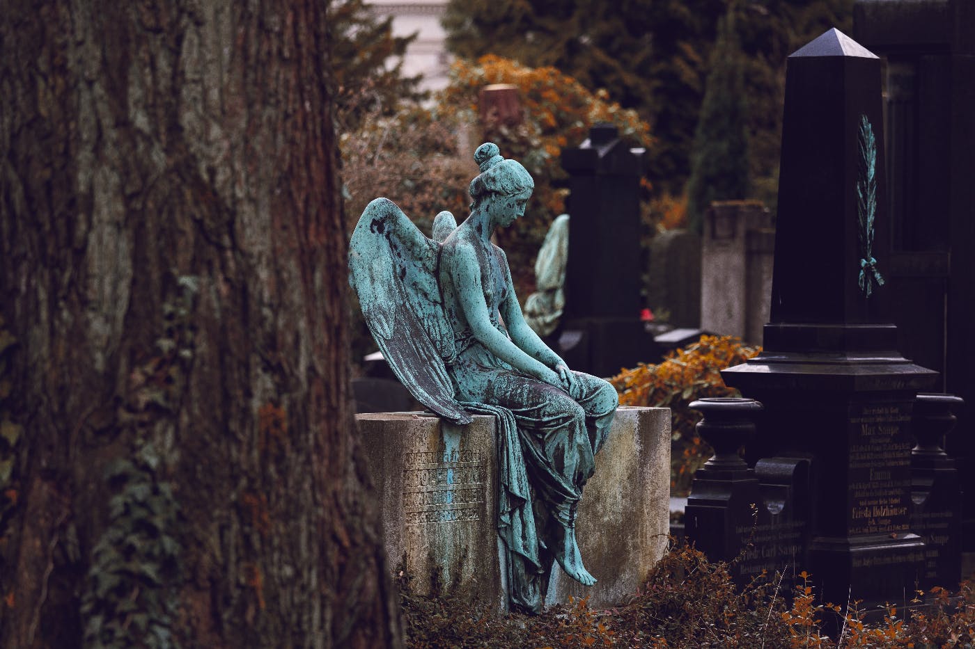 am angel sitting on a gravestone